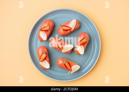 Eclari di fragole con foglie di cioccolato bianco Foto Stock