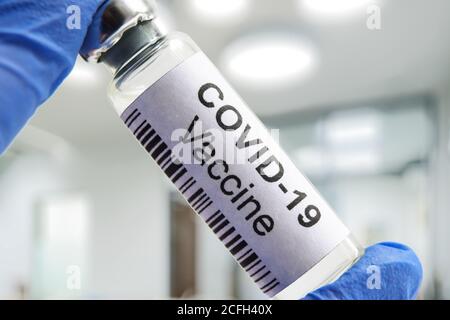 COVID-19 vaccino del coronavirus in laboratorio, flacone di farmaco per la cura del virus della corona SARS-COV-2. Coronavirus farmaco in primo piano mani. Concetto di medicina Foto Stock