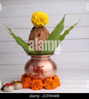 kalash di rame con noce di cocco e foglie di mango con haldi kumkum e decorazione floreale. essenziale in puja indù. Foto Stock