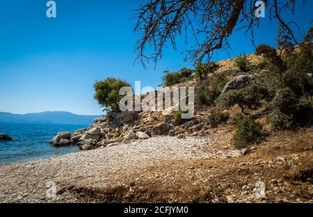 Una spiaggia incontaminata deserta sulla periferia della città balneare di Mytikas in una bella giornata estiva chiara e soleggiata. Foto Stock