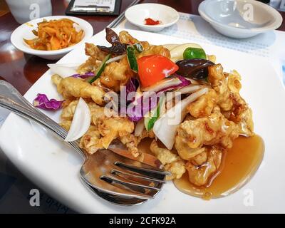 Tangsuyuk, o maiale dolce e acerbo, un popolare piatto di maiale coreano-cinese dolce e acerbo. Carne croccante fritta in salsa dolce e piccante. Foto Stock