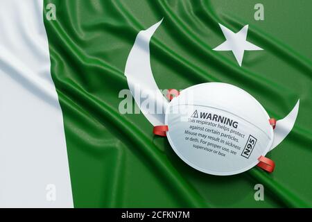 Maschera medica chirurgica coronavirus sulla bandiera nazionale pakistana. Malattia, pandemia, virus covid-19 in Pakistan, concetto 3d rendering illustratio Foto Stock