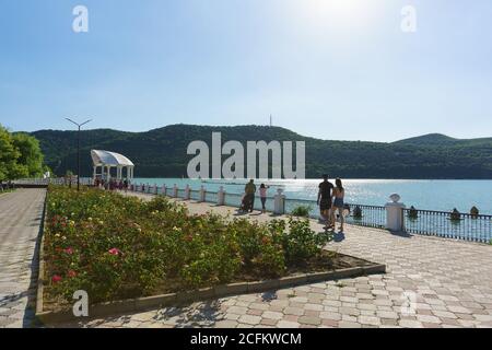 Russia, regione di Krasnodar, Novorossiysk, Abrau-Durso villaggio-12 giugno 2018: Roses sulla passeggiata Sunny del pittoresco lago di montagna Abrau nel Foto Stock