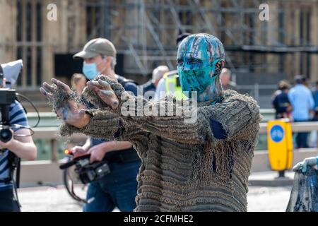 Durante la manifestazione prende parte un protestore vestito per rappresentare l'inquinamento degli oceani.i gruppi di Extinction Rebellion Marine, Ocean Rebellion, ‘sestinzione della vita marina e la ribellione animale hanno marciato a Londra in una «marcia del dolore socialmente distanziata» per chiedere protezione agli oceani e per protestare contro l’inazione governativa globale per salvare i mari a causa del crollo del clima e dell’interferenza umana; e la perdita di vite, case e mezzi di sussistenza a causa dell'aumento del livello del mare. Foto Stock