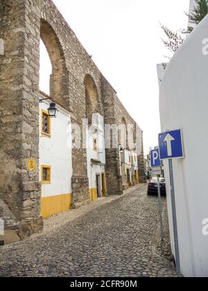 EVORA, PORTOGALLO - 06 ottobre 2010: Evora, Portogallo, 2010 ottobre: Case costruite negli archi di Aqueduto da agua de Prata a Evora, Portogallo Foto Stock