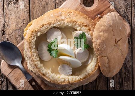 Zurek. Zuppa tradizionale polacca su tavolo di legno Foto Stock