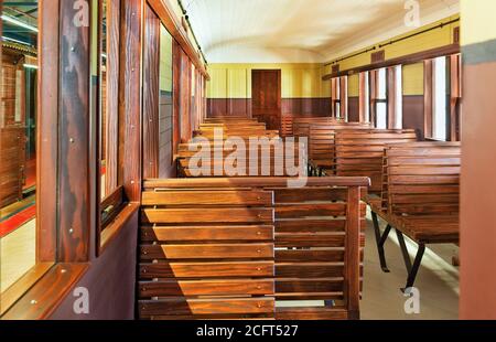 Vecchia carrozza ferroviaria con panchine in legno Foto Stock