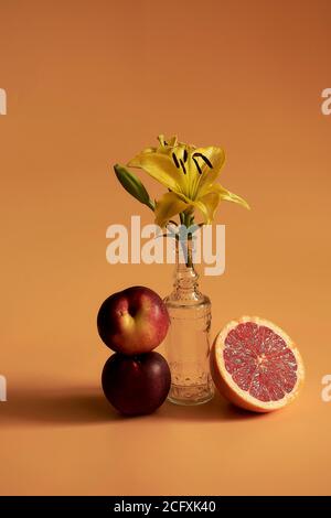 Ancora vita di due pesche su uno sfondo arancione. Foto Stock