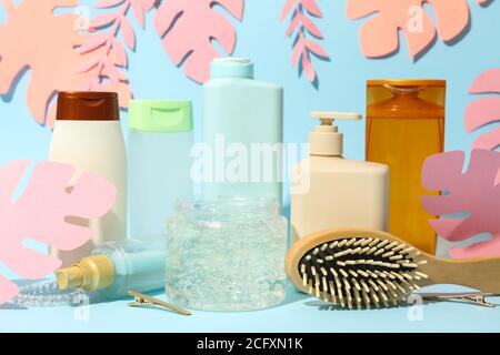 Composizione con accessori per parrucchieri e foglie di palmo di carta su blu sfondo Foto Stock