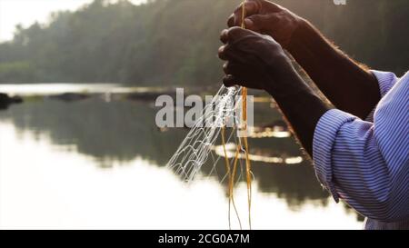 L'uomo indiano che prepara la rete di pesca Foto Stock