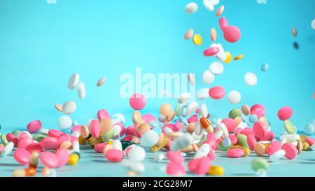 Congela il movimento di pillole colorate volanti su sfondo bianco. Concetto sanitario e medico Foto Stock