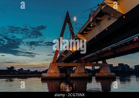 Il ponte di Millenium a Kazan, si riflette nelle acque del fiume Kazanka. Il ponte sul fiume è stato attraversato da un cavo. Il ponte con illuminazione notturna. Foto Stock