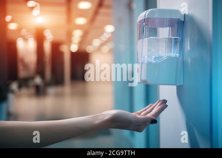 primo piano dell'igienizzatore automatico a mano con antisettico per prevenzione covid 19 Foto Stock