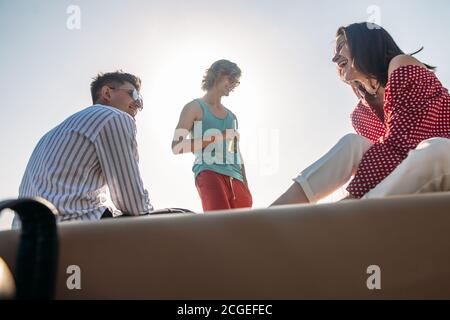 Gli amici a bere birre in battello partito. Gruppo di persone sulla festa yacht Foto Stock