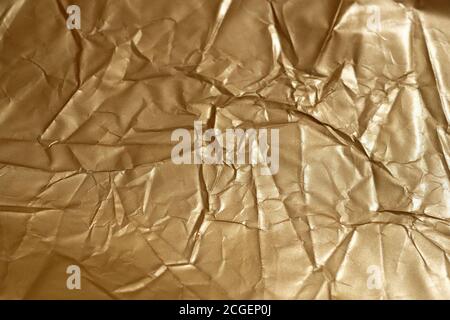 Carta di colore oro sgualcita. Sfondo dorato dalla vista superiore della carta. Superficie sgualcita della grana della carta marrone. Foto Stock