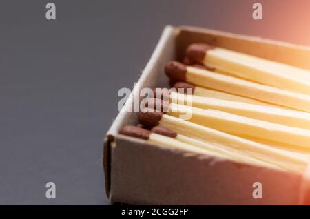 Corrispondenze nella casella, sfondo scuro. Fotografia macro. Primo piano. Corrispondenze in casella di corrispondenza aperta su sfondo nero con luce parassita Foto Stock