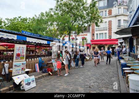 Turisti e artisti che vendono i loro dipinti al Place du Tertre a Montmartre Foto Stock