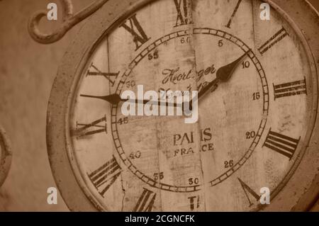 Quadrante con orologio con numeri romani d'aspetto vintage appeso alle pareti esterne, che mostra l'ora e l'arredamento in stile antico del quadrante dell'orologio. Foto Stock