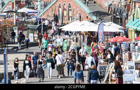 Brighton UK 12 settembre 2020 - il suo affollato lungo il lungomare di Brighton in un giorno soleggiato ma ventilato come il tempo caldo è previsto per diffondersi attraverso la Gran Bretagna nei prossimi giorni .. : Credit Simon Dack / Alamy Live News Foto Stock