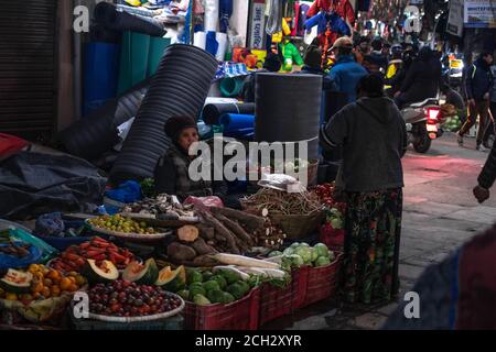 Kathmandu, Nepal - Dicembre 22 2019: Persone non identificate frequenta un mercato di strada locale per acquistare e vendere frutta, verdura e vestiti il 22 dicembre Foto Stock