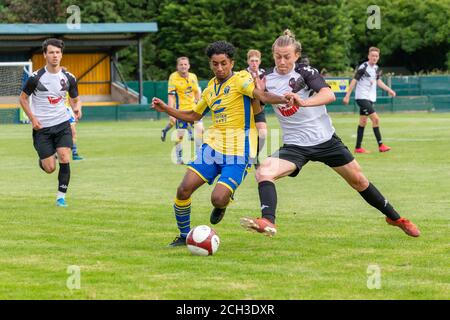 Jewad di Warrington Town AFC riceve una carica di spalla Da un giocatore di Salford City U23 al Cantilever Park Foto Stock