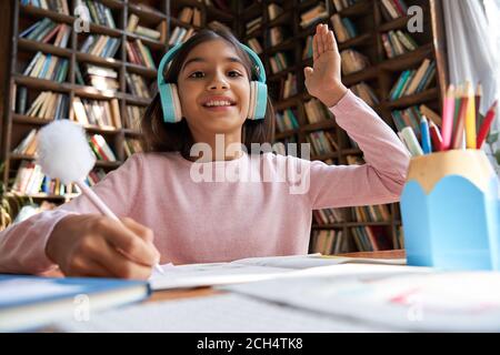 Scuola indiana ragazza alzando mano imparare on-line su video zoom chiamata, vista webcam. Foto Stock