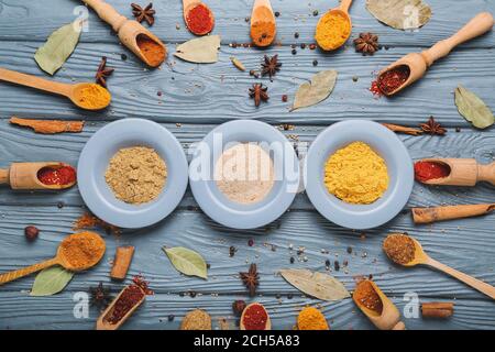 Composizione con diverse spezie aromatiche su sfondo ligneo Foto Stock