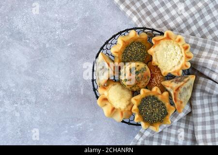 Pasticceria, fatayer o samosa, manaqeesh con zaatar e formaggio bianco in cesto di metallo Foto Stock