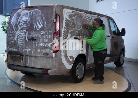 L'artista Ricky Minns, noto anche come "Ruddy Muddy", crea un'opera d'arte su un furgone come parte dell'iniziativa di sensibilizzazione nazionale di Ford in collaborazione con Time To Change, Che mira a diffondere la consapevolezza della salute mentale in tutto il Regno Unito, esortando i conducenti ad affrontare lo stigma della salute mentale - il vero elefante nella stanza, prima della Giornata Mondiale della Salute mentale mercoledì 10 ottobre. Foto Stock