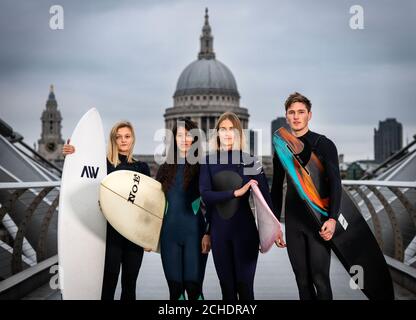 SOTTOPOSTO A EMBARGO PER il 0001 MARTEDÌ 27 NOVEMBRE SOLO PER USO EDITORIALE (da sinistra a destra) Surfers Jessica Rowe, Veranika Lim, Sophie Hellyer e Frank Hodgson attraversano Londra e Otilde;s Millennium Bridge come una partnership tra Lee Valley Regional Park Authority e The Wave per creare una destinazione per il surf nell'entroterra della capitale per persone di tutte le età, background e abilità. Foto Stock