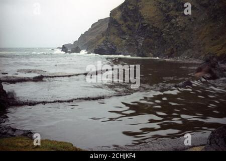 Il mare è diventato nero con inquinamento da petrolio nella piccola baia di Garths Wick, vicino alla zona dove la petroliera MV Braer è bloccata sulle rocce in Shetland. Foto Stock
