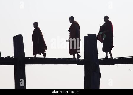 Sagome della gente locale che cammina su u bien ponte Mandalay, Myanmar Foto Stock