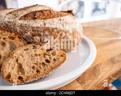 Pane di pasta acida. Particolare attenzione al pane di pasta frolla tagliato con spazio di copia bokeh di sfondo. Foto Stock