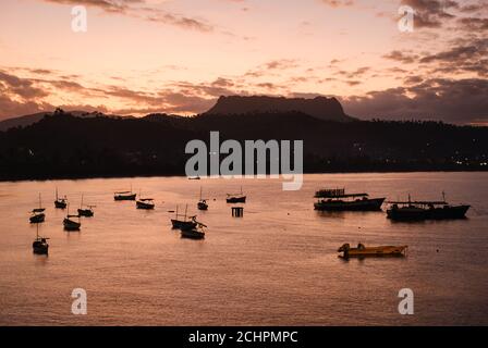 BARACOA, CUBA - CIRCA GENNAIO 2020: Baia di Baracoa e barche durante il tramonto. Foto Stock