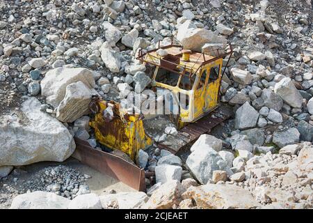 Vecchio trattore giallo distrutto in montagna. Foto Stock