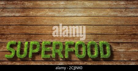 Superfood fatto di erba su sfondo di legno Foto Stock