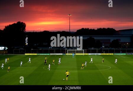 Una visione generale dei giocatori in azione mentre il sole tramonta durante la partita della Carabao Cup al Kassam Stadium di Oxford. Foto Stock