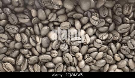 Chicchi di caffè, immagine di sfondo, vista dall'alto, primo piano. Foto Stock
