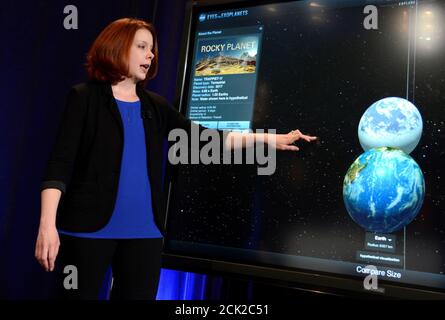 Space Telescope Science Institute astronomer Nikole Lewis uses a graphic to compare the size of Earth (bottom) with a recent discovery of an exoplanet, during a news conference to present new findings on exoplanets, planets that orbit stars other than Earth's sun, in Washington, U.S., February 22, 2017.                             REUTERS/Mike Theiler