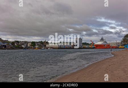 Guardando lungo il fiume South Esk verso il porto industriale di Montrose, con il villaggio di Ferryden, e diverse navi di fornitura offshore ormeggiate. Foto Stock