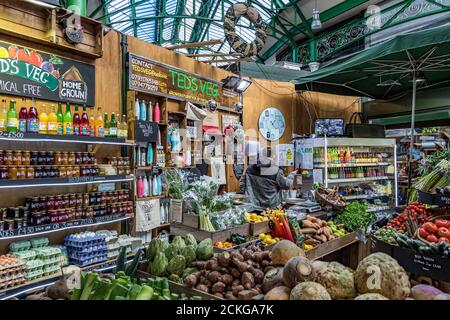 Un commerciante al Ted's Veg Stall in Borough Market, il più antico mercato alimentare di Londra, Southwark, Londra Foto Stock