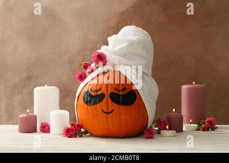 Candele e zucca con macchie sugli occhi su sfondo marrone Foto Stock