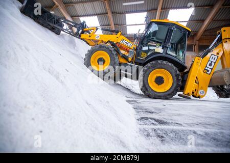 Teterow, Germania. 09 settembre 2020. Un escavatore spinge il sale stradale in un magazzino nel deposito di manutenzione stradale. I futuri addetti alla manutenzione stradale del Meclemburgo-Pomerania occidentale sono addestrati presso il deposito di manutenzione stradale di Teterow. Il reparto di manutenzione stradale è responsabile di circa 200 chilometri di strade statali e federali. Credit: Jens Büttner/dpa-Zentralbild/ZB/dpa/Alamy Live News Foto Stock