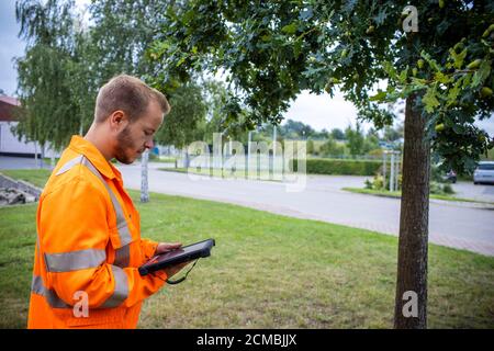 Teterow, Germania. 09 settembre 2020. Il tirocinante fino a Breitsprecher controlla un albero di strada e confronta i dati in un catasto con tutti gli alberi di strada. I futuri addetti alla manutenzione stradale del Meclemburgo-Vorpommern sono addestrati nel reparto di manutenzione stradale di Teterow. Il reparto di manutenzione stradale è responsabile di circa 200 chilometri di strade statali e federali. Credit: Jens Büttner/dpa-Zentralbild/ZB/dpa/Alamy Live News Foto Stock