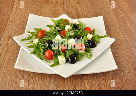 Insalata di rucola con pomodori ciliegini e uva Foto Stock