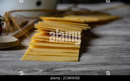 primo piano su tavola in legno, con vista su fogli di lasagna - fuoco selettivo Foto Stock
