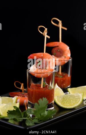 Antipasto di shish kebab con gamberi e chorizo ​​sausages con salsa barbecue in un bicchiere Foto Stock