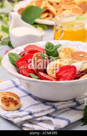 Porridge di minuscoli pancake con frutti di bosco. Cibo alla moda. Foto Stock