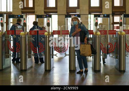 Mosca, Russia - 14 settembre 2020: Ingresso della metropolitana di Mosca. Passaggio attraverso i tornelli. Tempo pandemico del coronavirus. Alcune persone indossano / indossano / usano Foto Stock