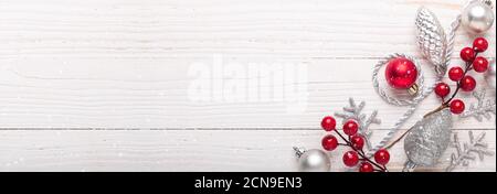 Regali di natale in argento e rosso su sfondo di legno bianco. Vista dall'alto. Spazio di copia. Banner lungo Foto Stock